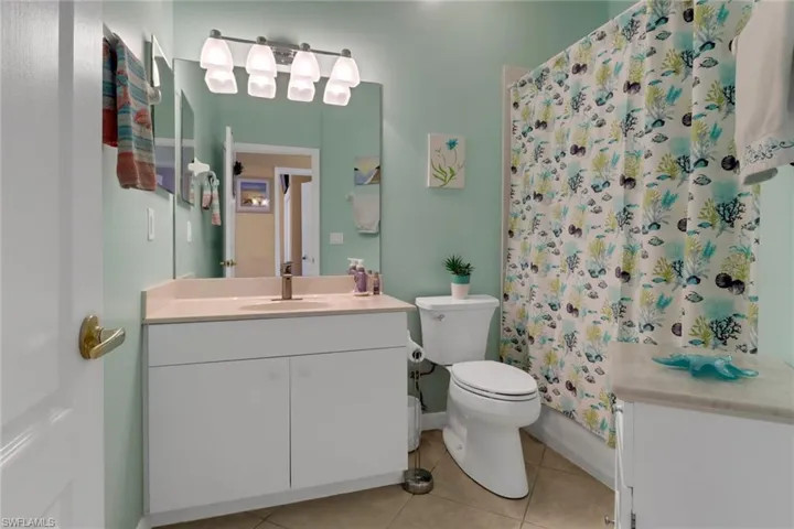 Full bath featuring vanity and tile patterned flooring