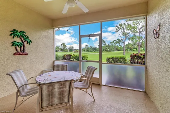 Patio featuring view of golf course and healthy amount of natural light