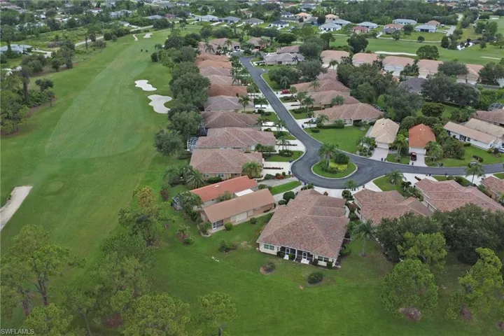 Aerial view of property's location featuring nearby suburban area and a golf course