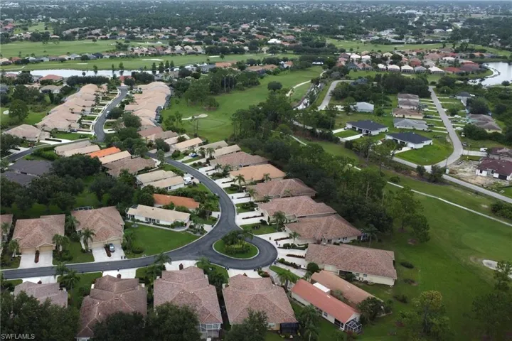 Aerial overview of property's location with nearby suburban area, a large body of water, and a golf course