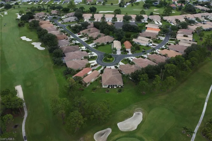 Aerial view of property's location featuring nearby suburban area and a golf course