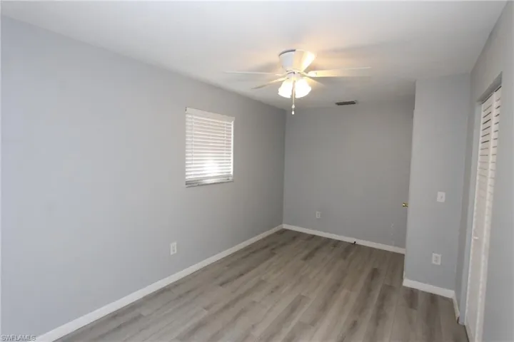 Unfurnished bedroom with ceiling fan and light hardwood / wood-style flooring