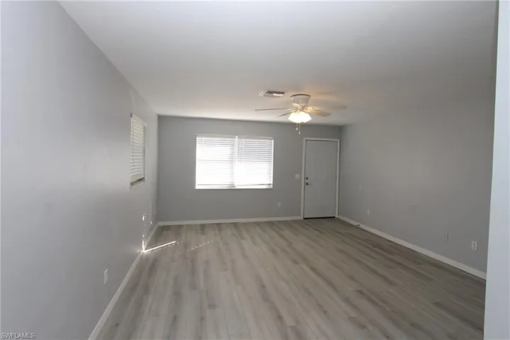 Unfurnished room with light hardwood / wood-style floors and ceiling fan