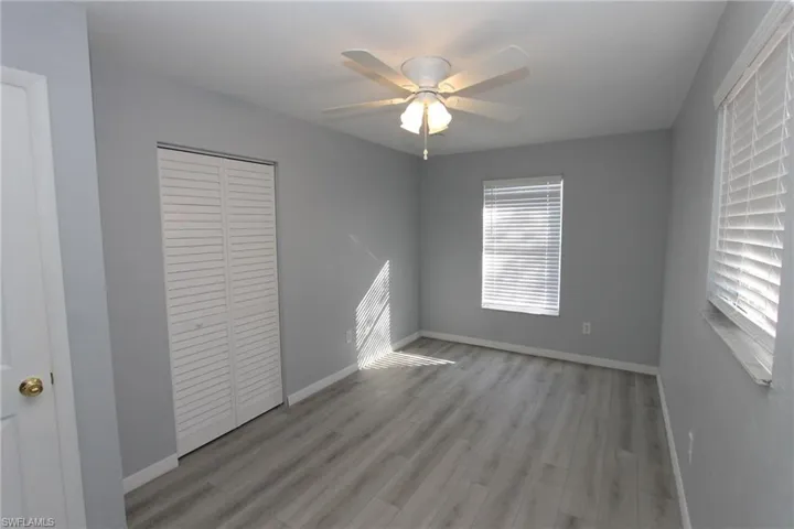 Unfurnished bedroom with ceiling fan, light hardwood / wood-style floors, and a closet