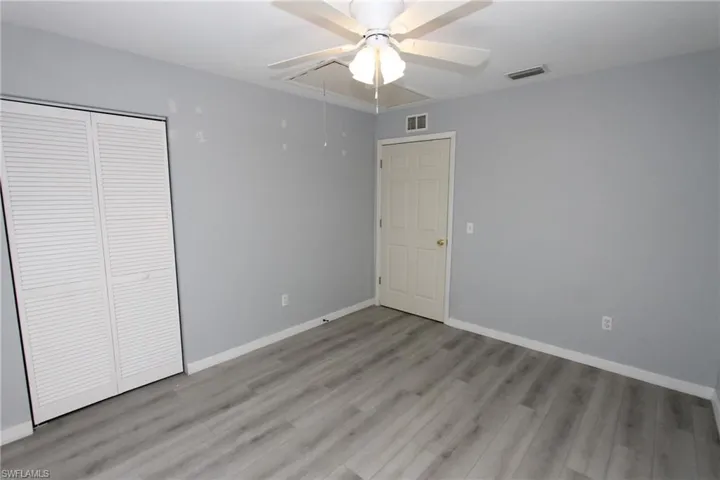 Unfurnished bedroom with ceiling fan, light hardwood / wood-style floors, and a closet