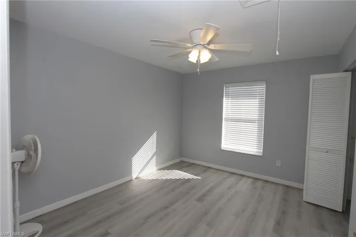 Unfurnished bedroom with ceiling fan and light hardwood / wood-style flooring