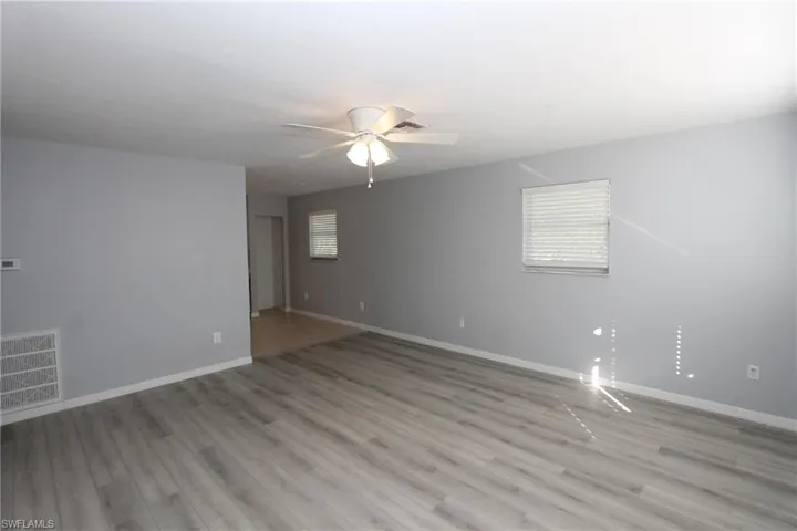 Unfurnished room with light hardwood / wood-style flooring and ceiling fan