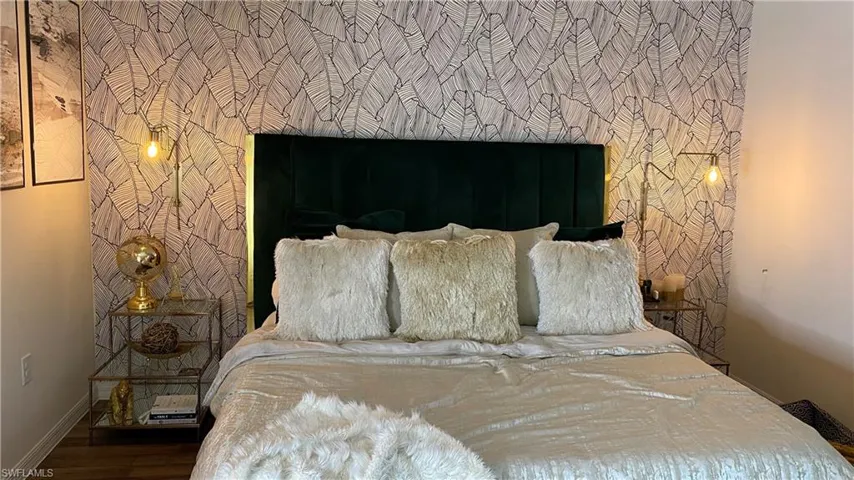 Bedroom featuring baseboards and wood finished floors