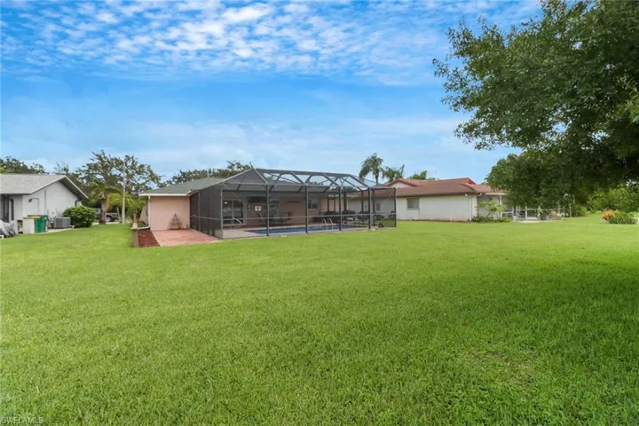 Rear view of home showcasing the expansive lot