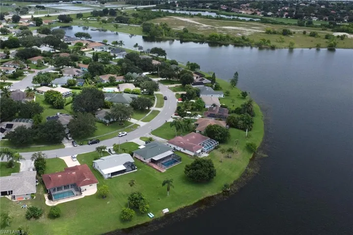 Birds eye view of property with a water view