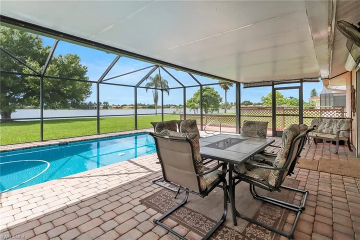 View of pool featuring a lawn, a lanai, and a patio