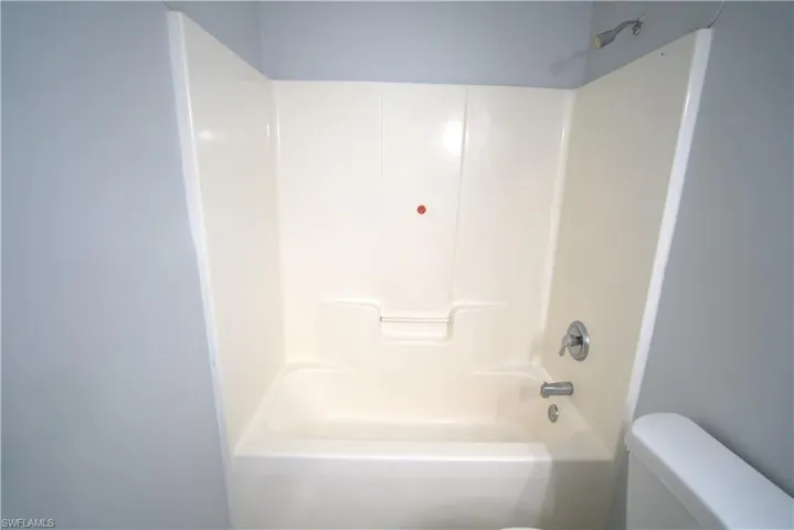 Bathroom featuring toilet and bathtub / shower combination