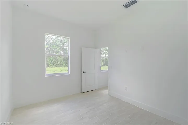 Empty room featuring plenty of natural light and light wood-style flooring