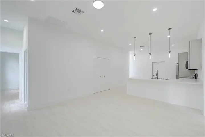 Unfurnished living room with light wood-style floors and recessed lighting