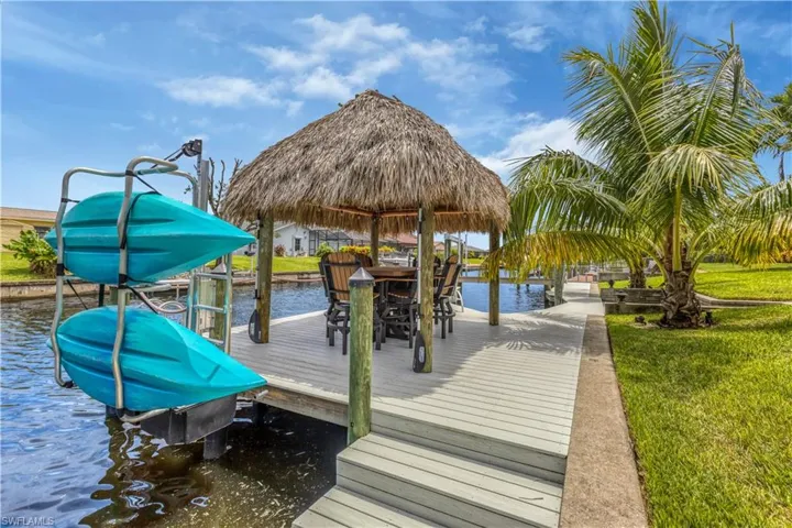 View of dock with a water view and a yard