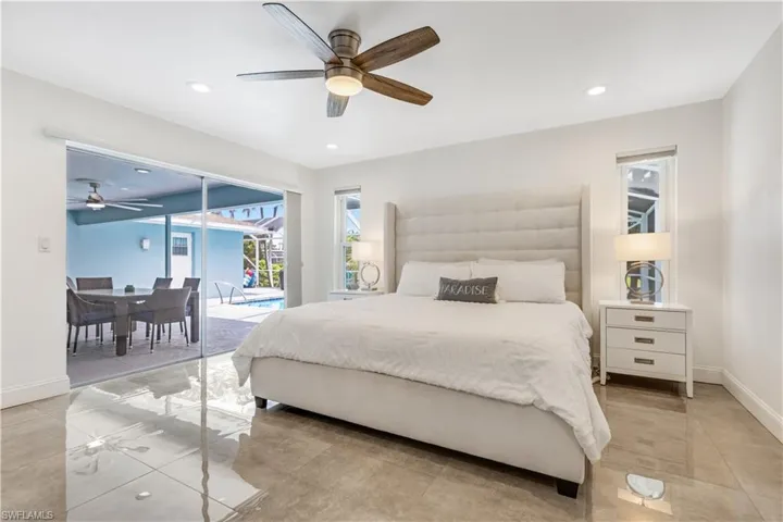 Bedroom featuring ceiling fan, access to exterior, and light tile patterned floors