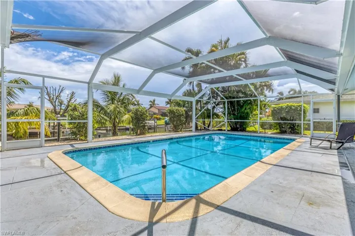 View of pool with a patio and a lanai
