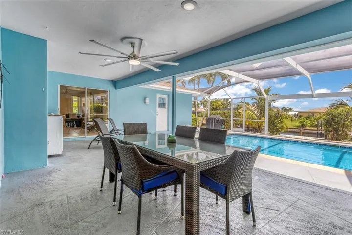 View of swimming pool featuring ceiling fan