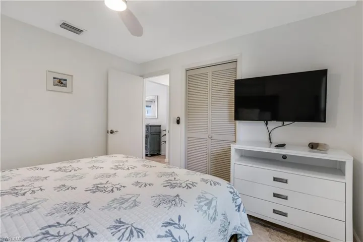Bedroom with ceiling fan and a closet