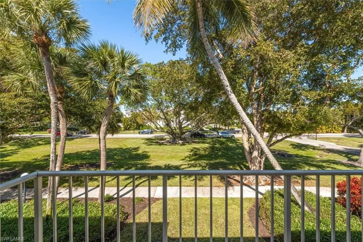 View of community featuring a balcony facing wide landscaped area