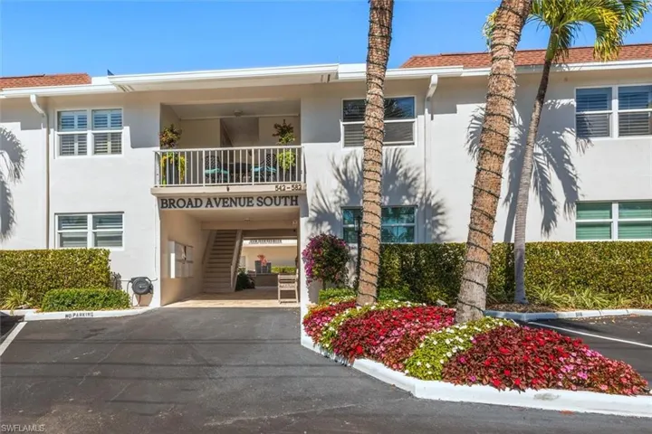 View of apartment building / complex with uncovered parking