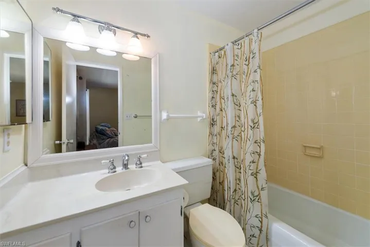 Full bathroom featuring shower / tub combo and vanity