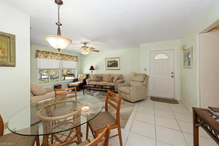 Dining room with ceiling fan and light tile patterned floors