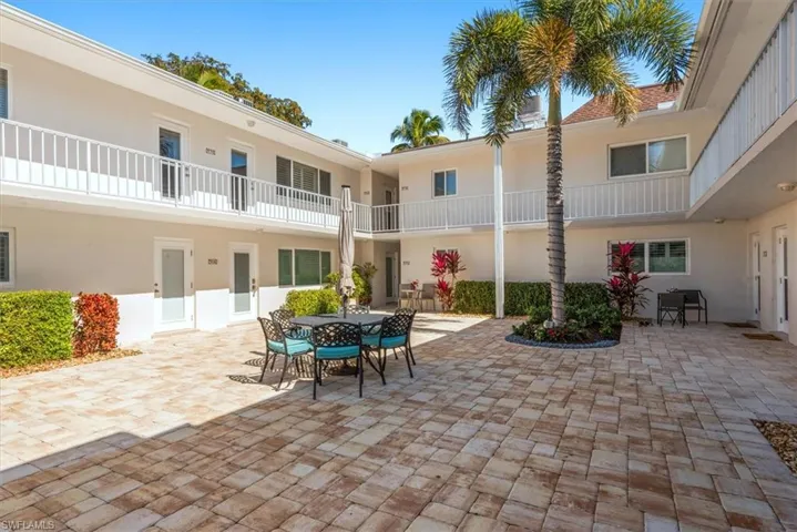 Paver patio with outdoor dining - facing unit on second floor corner