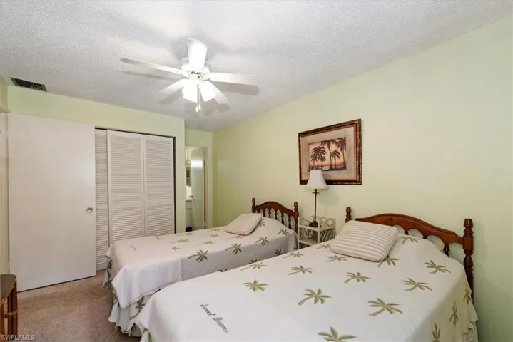 Bedroom with a closet, carpet floors, and ceiling fan with access to balcony