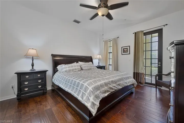 Bedroom with dark wood-type flooring and ceiling fan