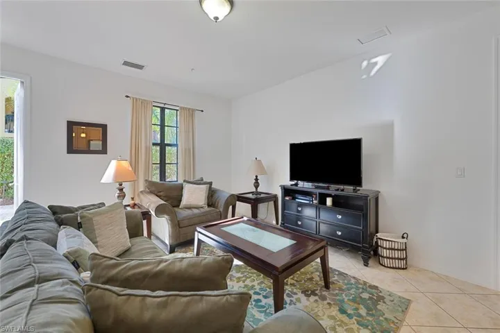 Living area with light tile patterned floors