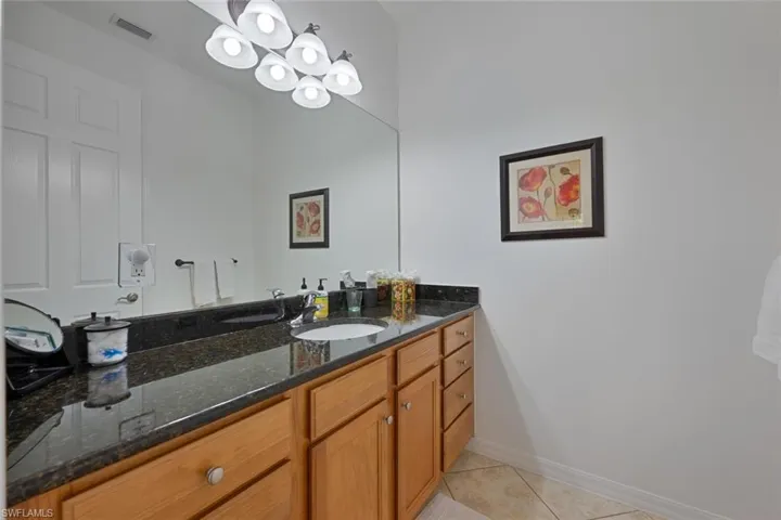 Bathroom featuring vanity and light tile patterned flooring