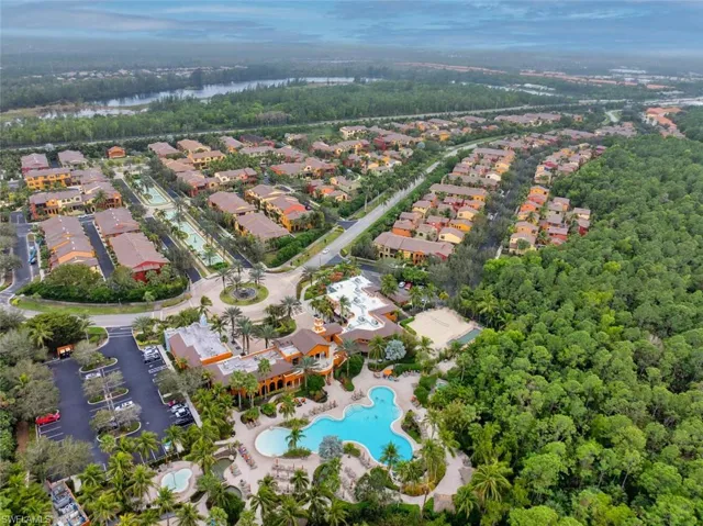 Aerial view of property and surrounding area with nearby suburban area