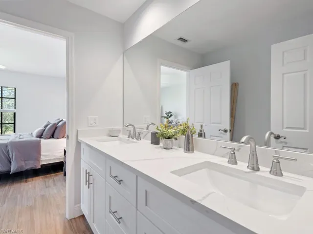 Bathroom with hardwood / wood-style floors and double vanity