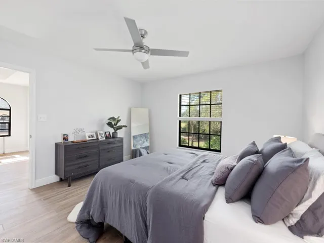 Bedroom with ceiling fan and light hardwood / wood-style flooring