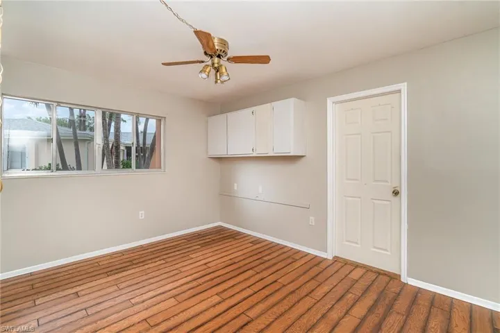 Empty room featuring hardwood / wood-style floors and ceiling fan