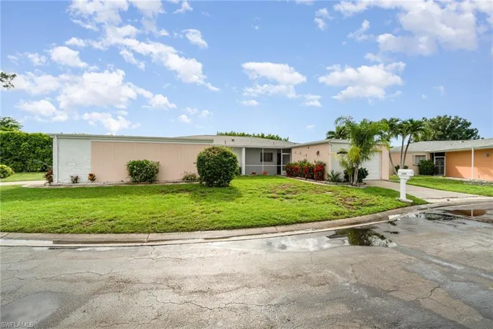 View of front of home featuring a garage and a front yard