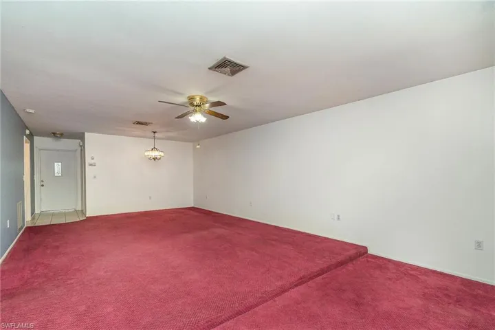 Empty room featuring carpet and ceiling fan