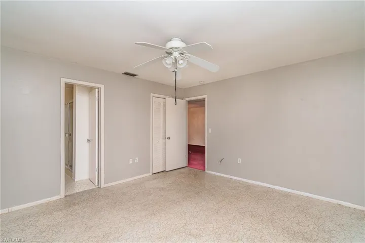Unfurnished bedroom with a closet, ceiling fan, and carpet floors