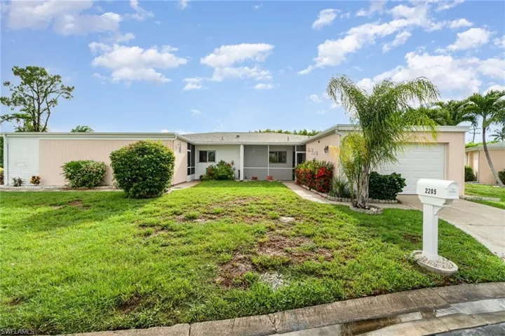 Ranch-style house with a garage and a front yard