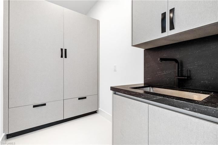 Laundry - Laundry Tub with Quartz Countertops and Custom Cabinetry for SAMSUNG Washer & Dryer