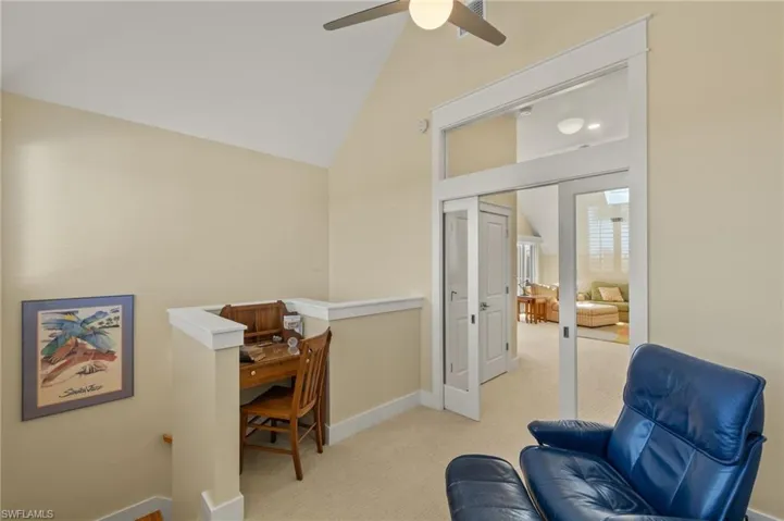 Sitting room with light carpet, lofted ceiling, and ceiling fan