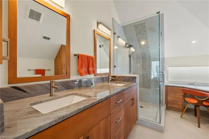 Bathroom with a shower with door and vanity