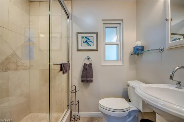 Full bath with a sink and a stall shower