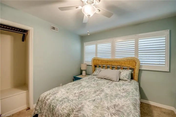 Bedroom featuring ceiling fan and baseboards