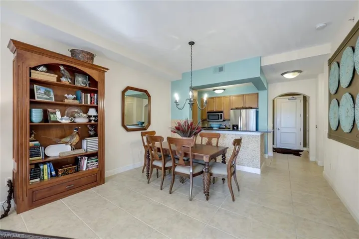 Dining area featuring a notable chandelier and light tile patterned floors