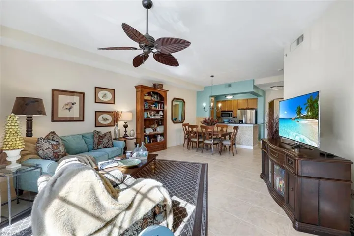 Tiled living room featuring ceiling fan