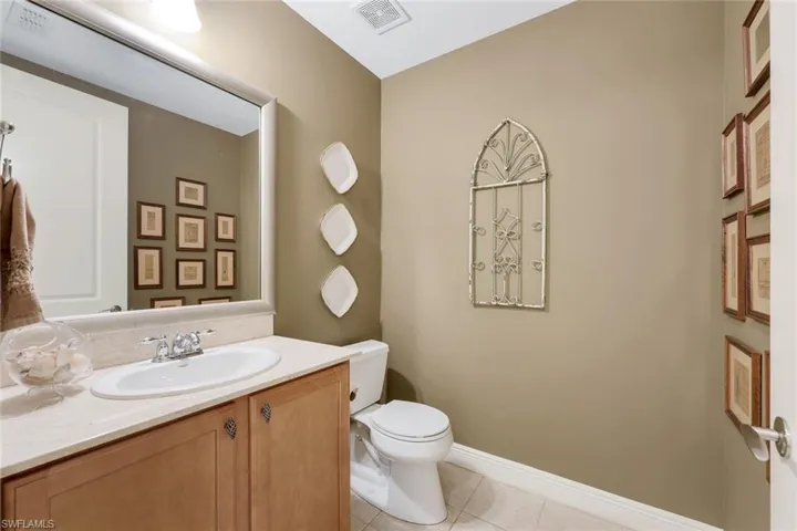 Bathroom with tile patterned flooring, vanity, and toilet