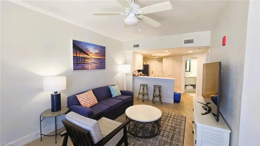 Living room featuring light wood-type flooring, ceiling fan, and recessed lighting
