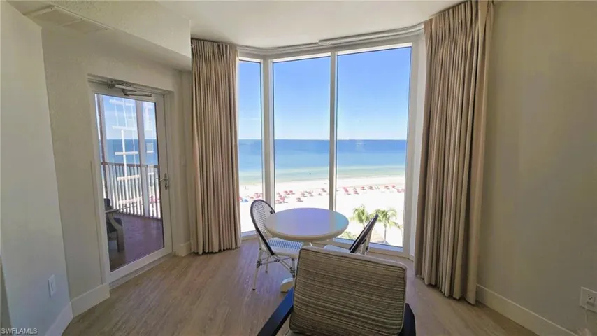 Dining area featuring view of beachfront and wood finished floors